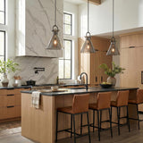 Aris Matte Black and Smoke Glass geometric pendant in a Modern Farmhouse Kitchen with light wood island and leather bar stools.