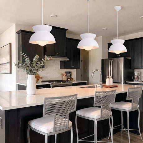 A modern kitchen with three Varo Pendant 15", Textured White fixtures hanging over a white quartz island featuring black cabinetry and silver mesh bar stools.