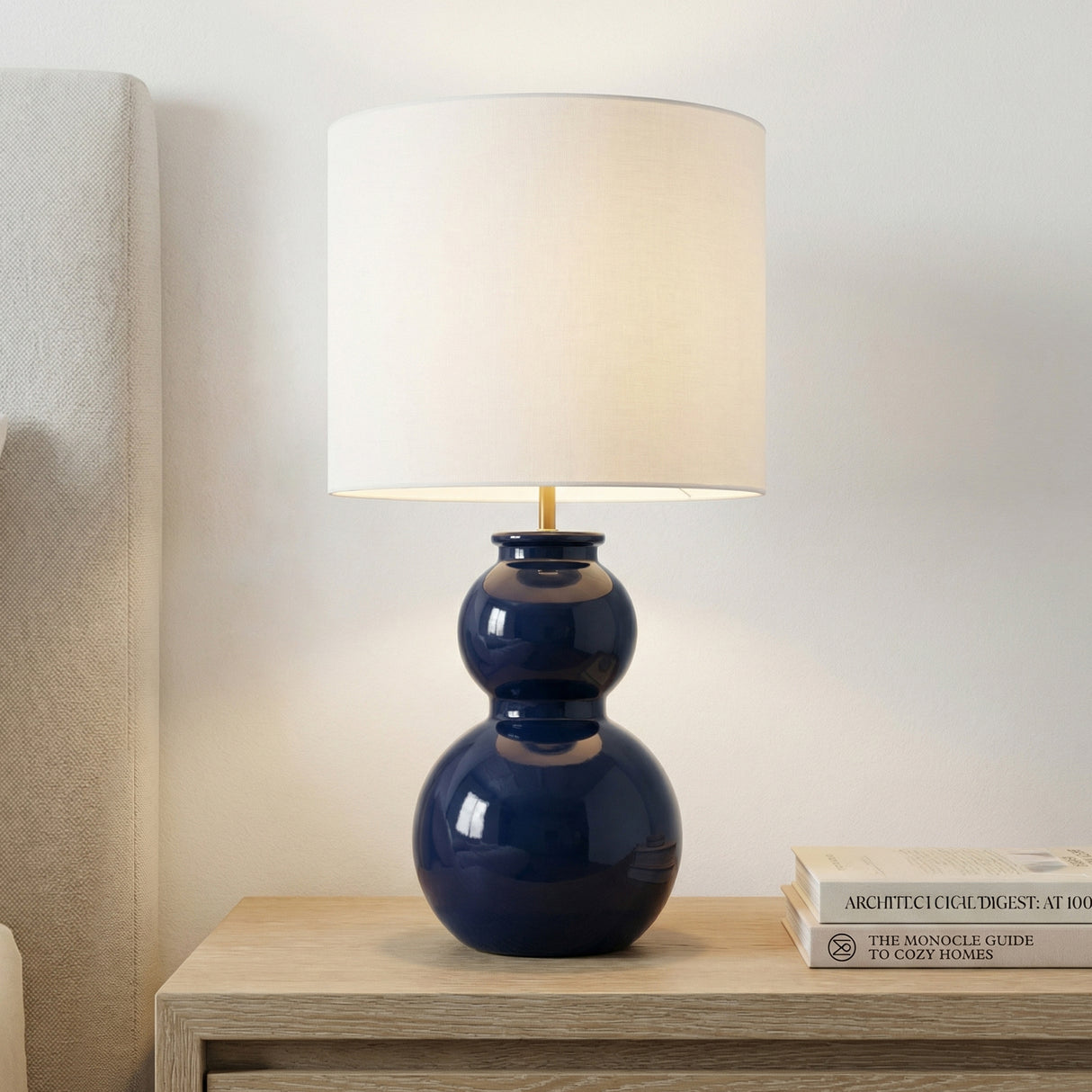 Truett Table Lamp 27", Glossy Navy globe Table Lamp in a Transitional Bedroom with a light wood nightstand.