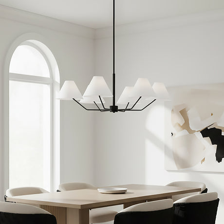 Wallace 6 Light Chandelier 38, Matte Black - A matte black chandelier with white conical shades hangs above a light wood dining table with upholstered chairs, with a large arched window in the background and abstract art on the wall.