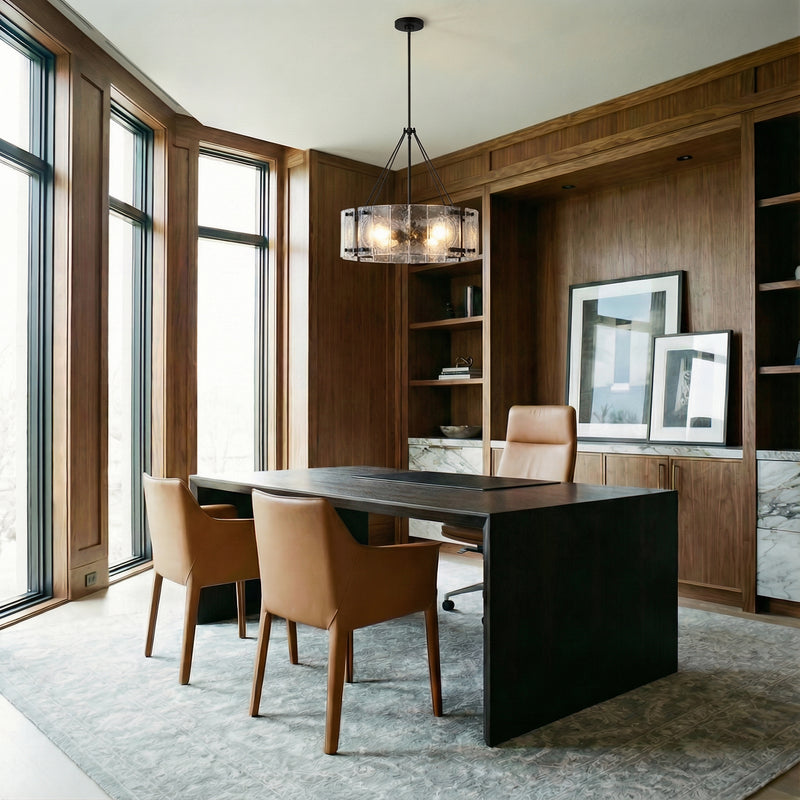 Rift Pendant 20", Matte Black drum-shaped glass and metal pendant in a Modern Office with dark wood paneling and a modern desk.