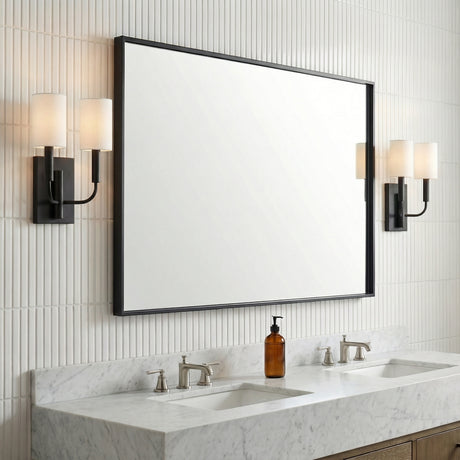 Matte Black linear Wall Sconce in a Transitional Bathroom with a white marble double vanity and ribbed wall tiles.