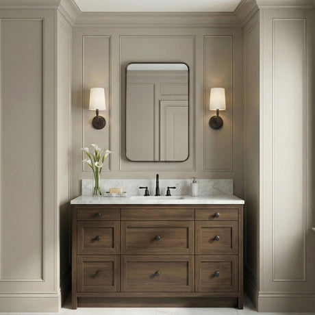Andrew Wall Sconce 12", Aged Iron geometric Wall Sconce in a Transitional Bathroom with a wood vanity and marble top.
