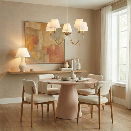 Anise 5 Light Chandelier 30", Satin Brass geometric Chandelier in a Transitional Dining Room with a pink pedestal dining table, with the Lucille Table Lamp in the background