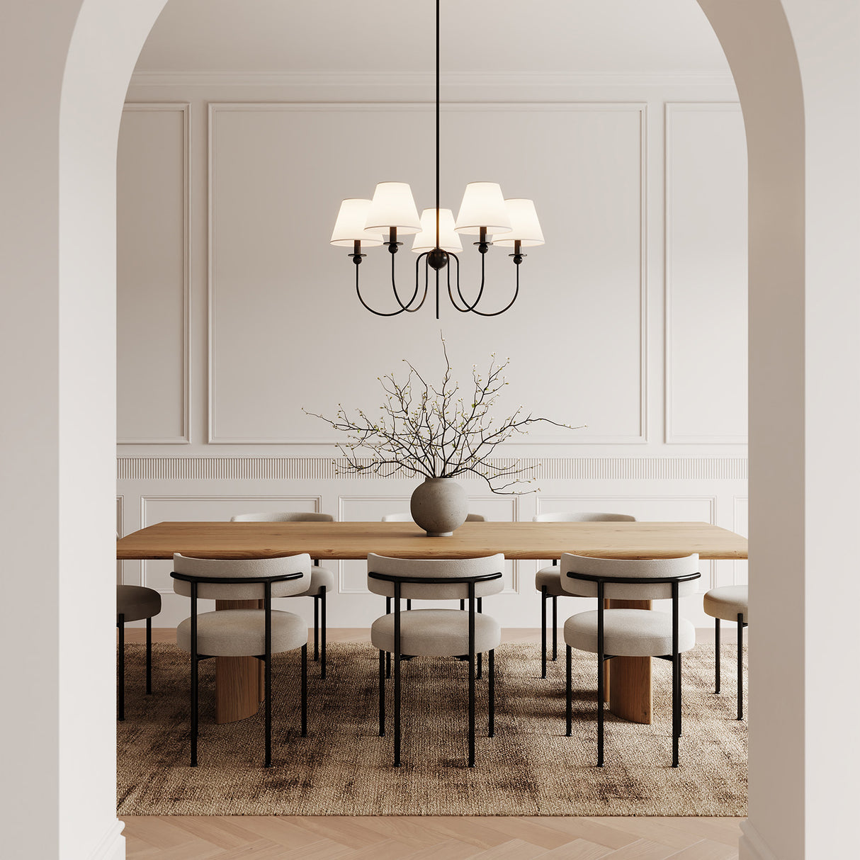Anise 5 Light 30" wide Chandelier 30", Matte Black with white fabric shades, is shown above a dining table with modern chairs and seating for 8