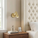 Nilo Pivot Wall Light 8, Satin Brass in a Modern Bedroom with a tufted headboard and wooden nightstand.