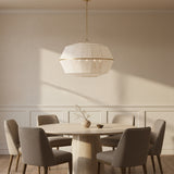 Birch Extra Large Pendant 32, Modern Brass and White Linen - A round dining table with chairs underneath a pendant light.