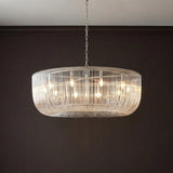 Amir Extra Large Chandelier 42", Polished Nickel linear Chandelier in a Contemporary Dining Room with dark espresso walls.