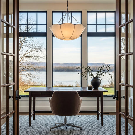 Ava 24" Pendant in Aged Iron finish with white fabric shade hung above a home desk in a sunroom overlooking a scenic lake view