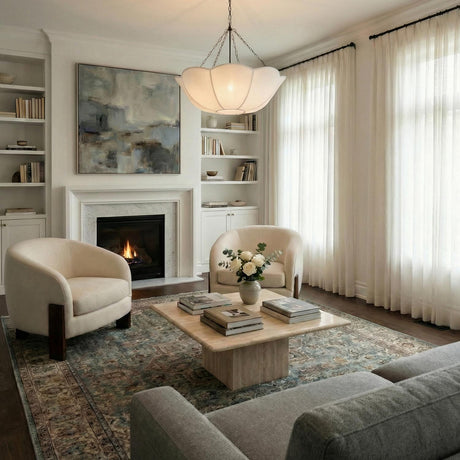 Ava Pendant 32", Aged Iron scalloped pendant in a Transitional Living Room with a marble coffee table and cream armchairs.