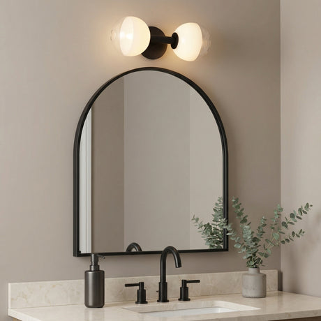 2 Light Matte Black globe vanity light in a Modern Bathroom with a matte black arched mirror and marble vanity.
