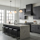 Merrick Pendant 8", Aged Iron globe pendant in an Industrial Kitchen with a concrete island and black cabinets.