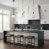 Merrick Pendant 8", Aged Iron globe pendant in a Modern Kitchen with a black marble waterfall island and leather stools.