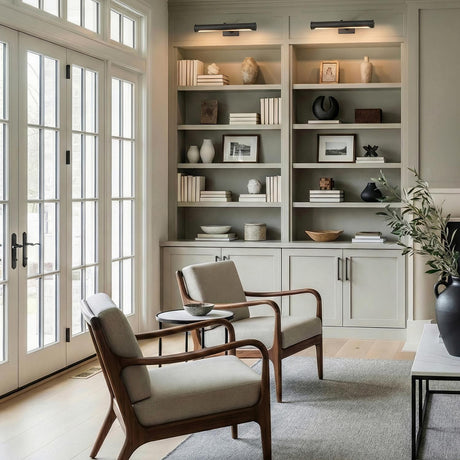 Keaton Picture Light 18", Aged Iron linear Wall Sconce in a Transitional Living Room with built-in bookshelves and mid-century chairs.