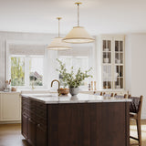 Two Gael Large 28" Pendants, with Gilded Brass detailing, shown in a large kitchen above a dark wood island with marble countertops.