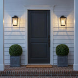 Harrison Outdoor Small Wall Light 10", Matte Black geometric Outdoor Wall in a Modern Farmhouse Outdoor with a black door and boxwood.