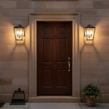 Harrison Outdoor Medium Wall Light 14", Textured Black - Front door flanked by two textured black outdoor wall lights.