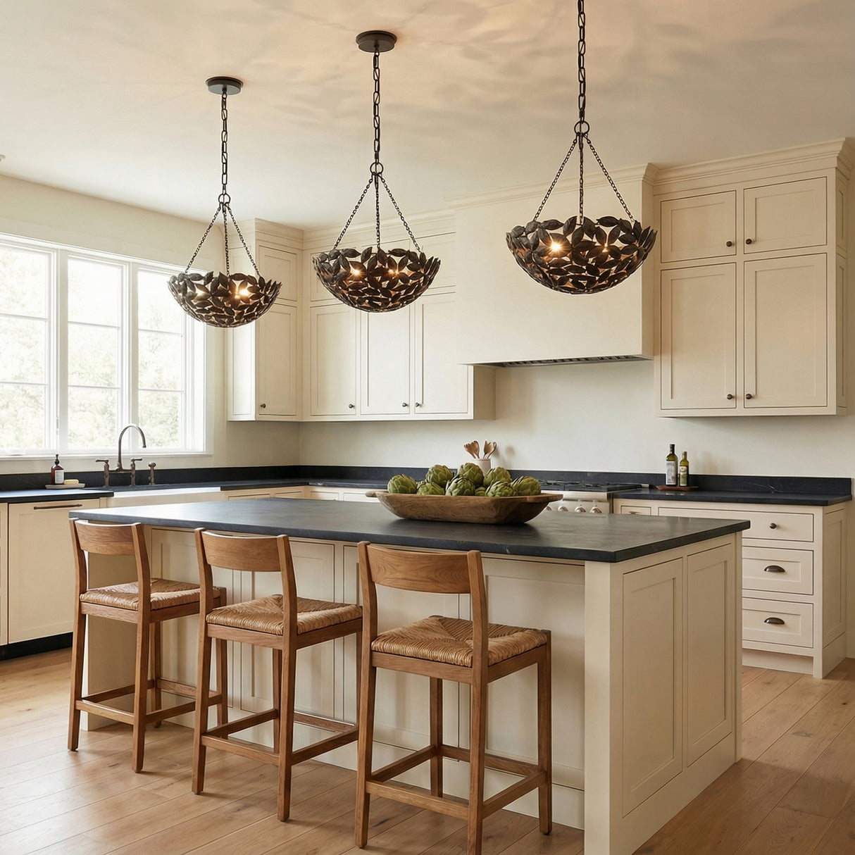 Floren Small Pendant 16", Aged Iron leaf design Pendant in a Modern Farmhouse Kitchen with a dark countertop island and woven bar stools.