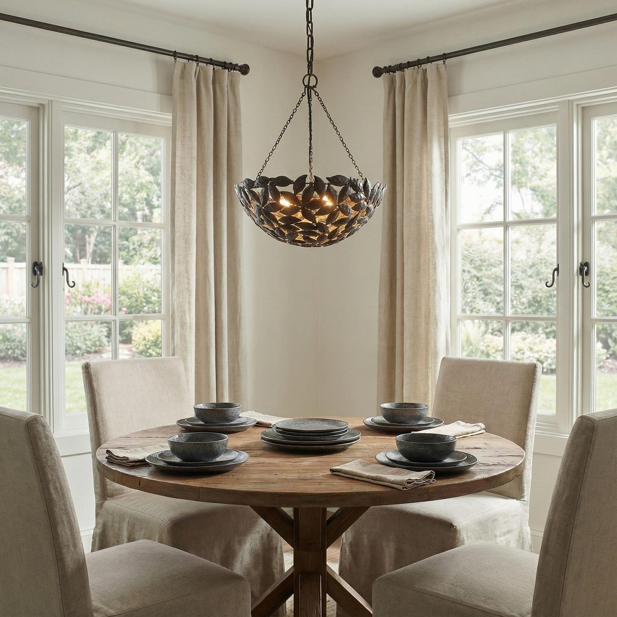 Floren Small Pendant 16", Aged Iron leaf design Chandelier in a Transitional Dining Room with a rustic oak table.