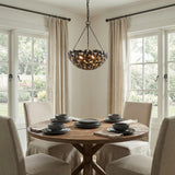 Floren Small Pendant 16", Aged Iron leaf design Chandelier in a Transitional Dining Room with a rustic oak table.
