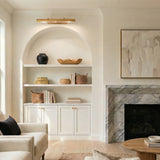 Gunther Picture Light 30", Modern Brass linear picture light in a Transitional Living Room with arched built-in shelves.