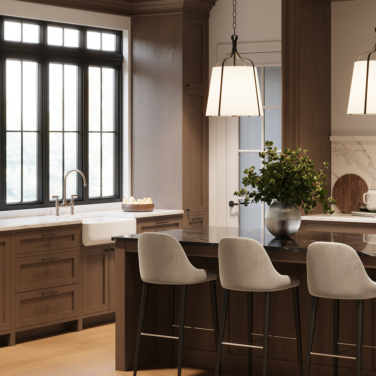 Isleton Pendants in an upscale transitional kitchen, hung above the dark marble island.