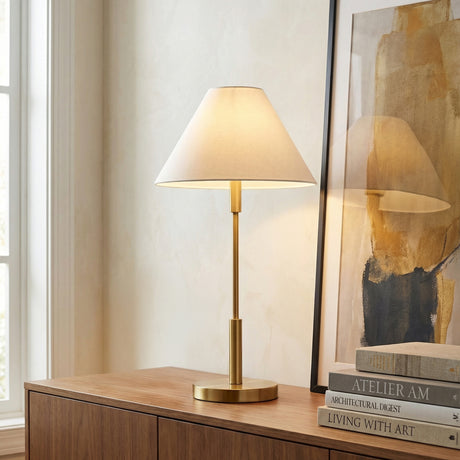 Elegant Table Lamp, Satin Brass linear table lamp in a Transitional Living Room with a wooden credenza and abstract art.