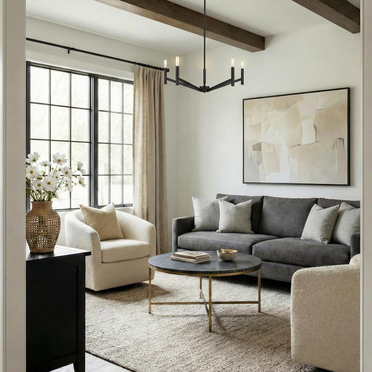 Foster 5 Light Chandelier, Matte Black geometric chandelier in a Transitional Living Room with a charcoal sofa and marble coffee table.