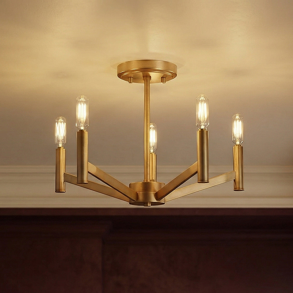 Satin Brass geometric semi-flush mount in a Transitional Dining Room with dark wood wainscoting.