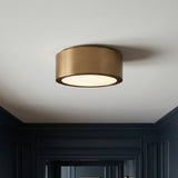 Satin Brass geometric flush mount in a Transitional Entryway with dark paneled walls.
