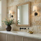 Emerson Wall Sconce 14", Aged Iron linear Wall Sconce in a Modern Farmhouse Bathroom with a stone wall and jute mirror.