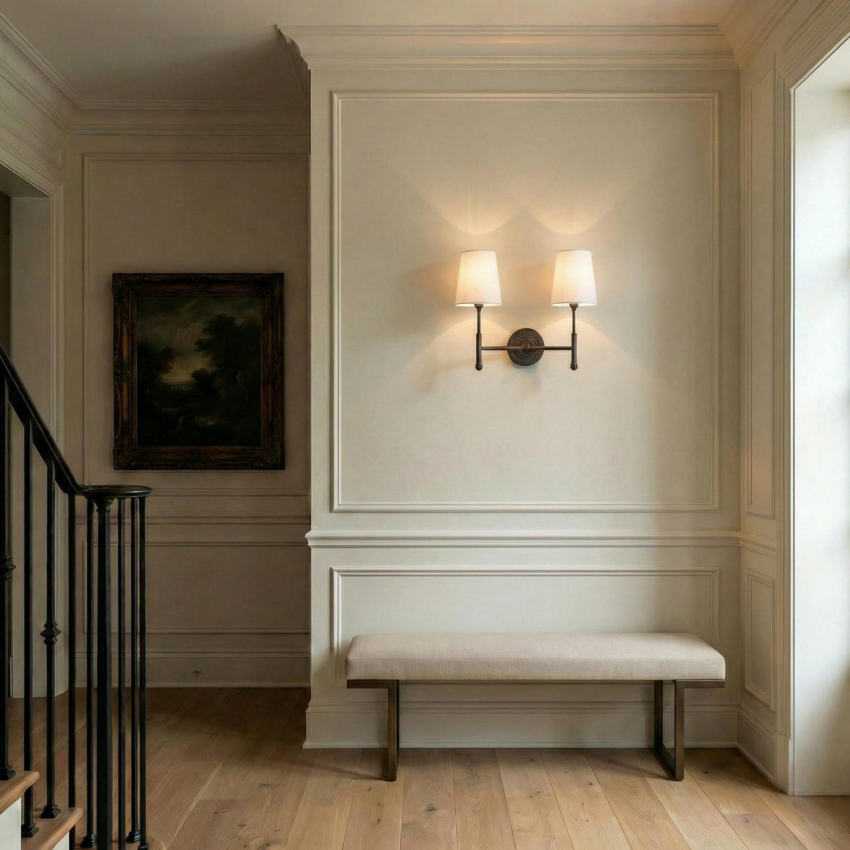 Emerson Double Wall Sconce 14", Aged Iron linear wall sconce in a Transitional Entryway with a tan upholstered bench and wall molding.