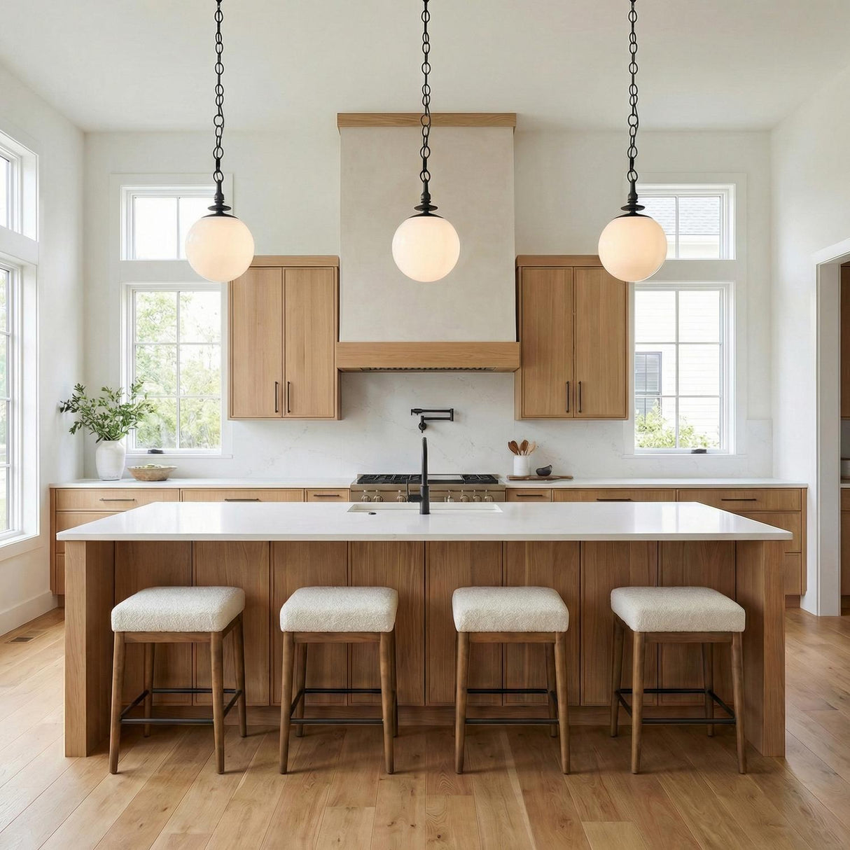 Emerson Medium Pendant 11", Aged Iron globe Pendant in a Modern Farmhouse Kitchen with a white marble island.