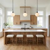 Emerson Medium Pendant 11", Aged Iron globe Pendant in a Modern Farmhouse Kitchen with a white marble island.