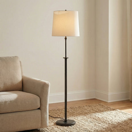 Emerson Floor Lamp, Aged Iron linear Floor Lamp in a Transitional Living Room with a textured beige armchair and jute rug.