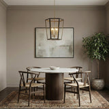Rawlin Lantern Pendant, Matte Black and Gold geometric pendant in a Transitional Dining Room with a marble table and wishbone chairs.