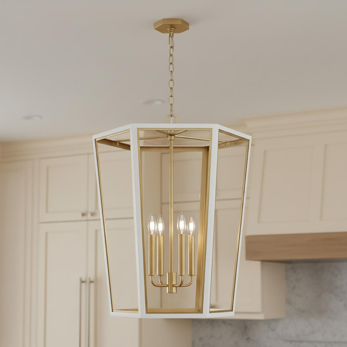A transitional kitchen features the Rawlin Medium Lantern Pendant 21", Matte White and Brushed Brass over the island beside cream shaker cabinets and a marble backsplash.