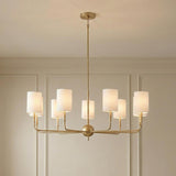 Remington 8 Light Chandelier, Satin Brass linear Chandelier in a Transitional Dining Room with picture frame molding walls.