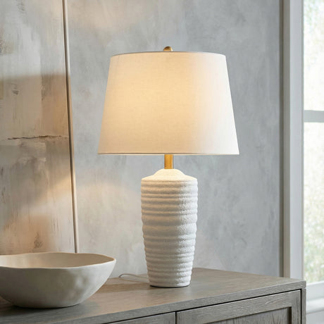 Joyce Table Lamp, Textured White linear Table Lamp in a Transitional Living Room with a grey wood console table and abstract art.