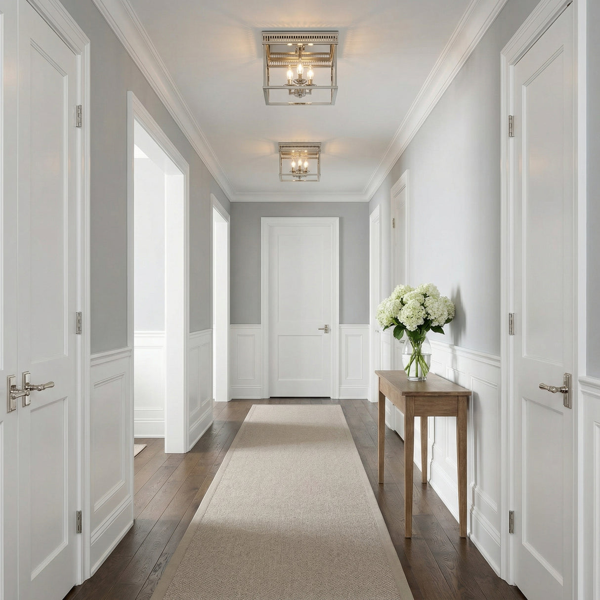 Rubin Flush Mount 13", Polished Nickel geometric flush mount in a Transitional Entryway with a wood console table and white hydrangeas.