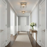 Rubin Flush Mount 13", Polished Nickel geometric flush mount in a Transitional Entryway with a wood console table and white hydrangeas.