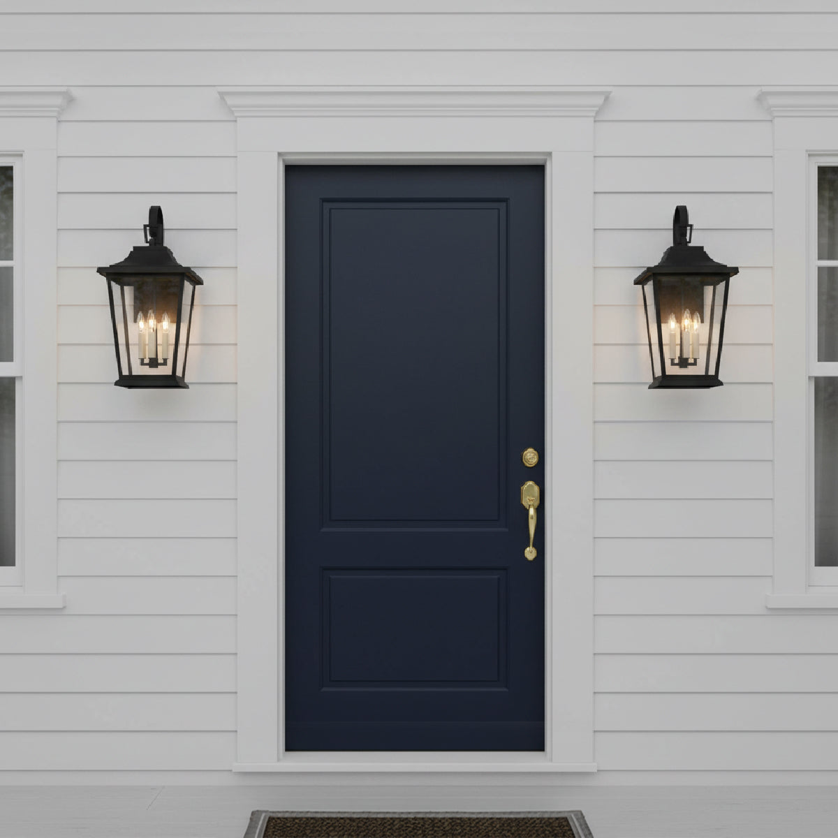 Navy blue front door on a white traditional house facade with two Dark gray door with two black Pembroke Medium Outdoor Wall Lights, 23" tall. 