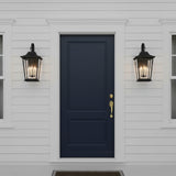Navy blue front door on a white traditional house facade with two Dark gray door with two black Pembroke Medium Outdoor Wall Lights, 23" tall. 