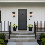 Pembroke Large Outdoor Wall Light 26", Textured Black - Black outdoor wall lights flanking a dark gray door.