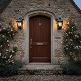 Fairmont Small Outdoor Wall Light 16, Textured Black - Two black lanterns flank a wood door with climbing roses and lavender.