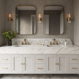 Three Barclay 13" tall Wall Sconces in Brass with clear fluted glass above a double vanity with two modern brass mirrors