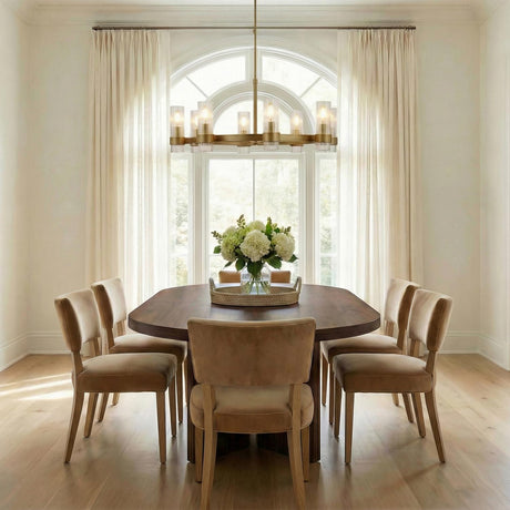 Barclay Medium Chandelier 33", Modern Brass linear chandelier in a Transitional Dining Room with a dark wood table and velvet chairs.