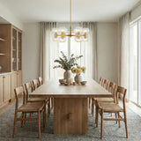 Matilda Small Chandelier 28", Modern Brass and Clear Glass globe Chandelier in a Contemporary Dining Room with a light oak dining table.