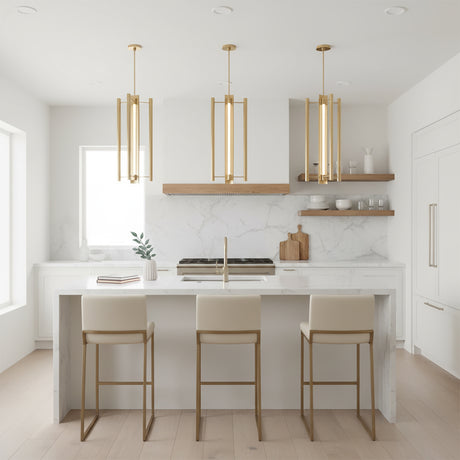 Robin Elongated 4 Light LED Pendant 16" Modern Brass - Three brass pendant lights hang above a kitchen island with bar stools, a marble backsplash, and a wooden range hood.
