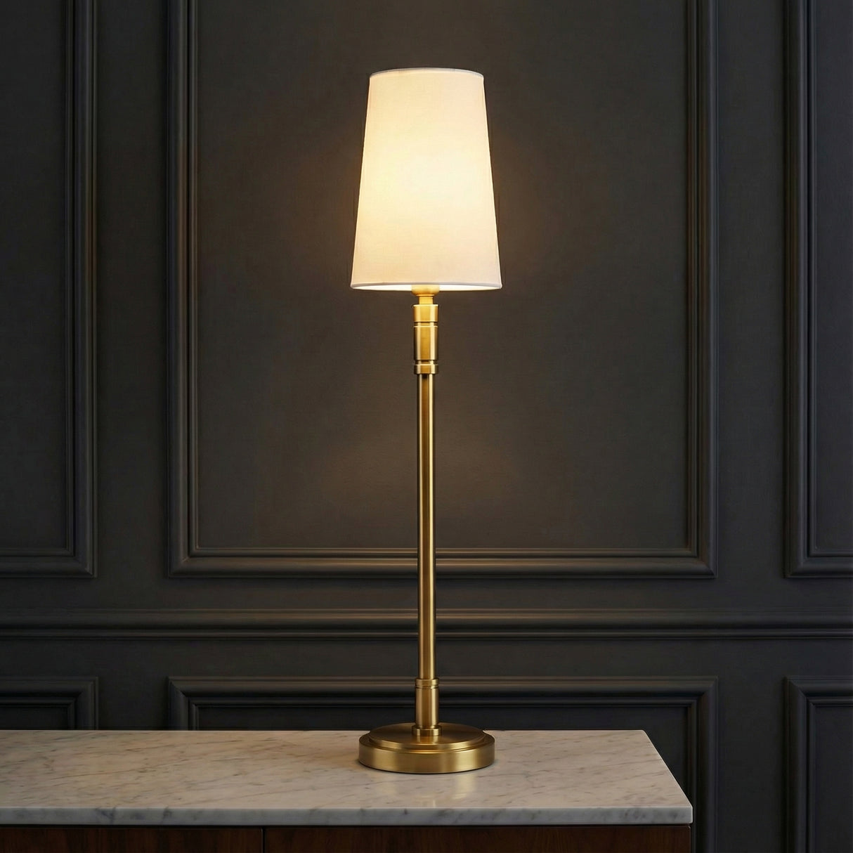 Petra Buffet Lamp 27, Modern Brass styled in a Modern Living Room with marble countertop and dark paneled walls